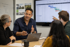 Experienced delivery leader discussing projects and priorities with his team